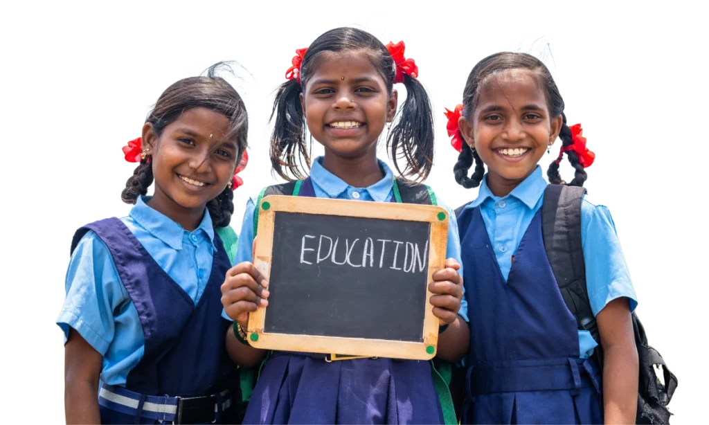 Three smiling schoolgirls holding a chalkboard that reads Education